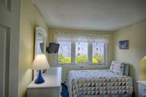 Bedroom with bright windows in our wells maine hotel