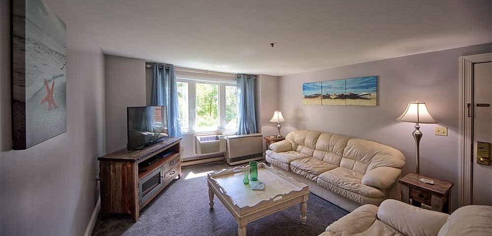 Living room with white comfortable couches with wells maine vacation rentals