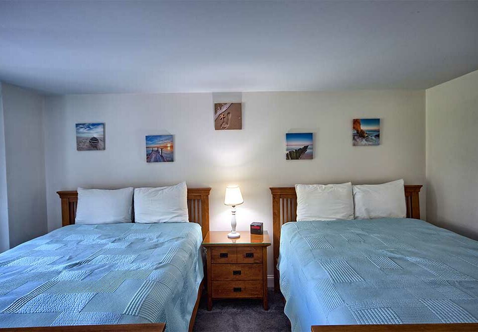 Bedroom with two queen beds in our wells Maine vacation rental near the beach
