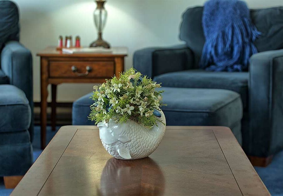flowers on wood coffee table in our wells maine vacation rentals