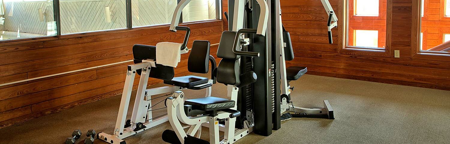 Fitness center with weights and exercise equipment at Wells, Maine hotel
